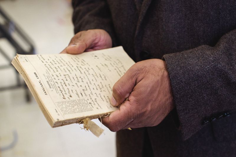 Govind Rao holding his grandfather's diary chronicling his path to engineering