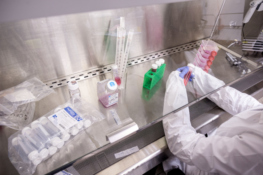 Chemist Stephanie Michelsen handles a container at her lab station.