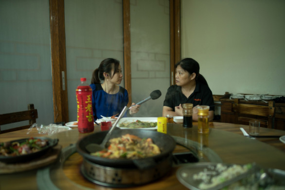 Li Guilian speaks to Marketplace over lunch since it was hard for her to request for time off at her new factory job. Li said it is harder to find good factory jobs in China. (Credit: Shanghai 808 Studio)