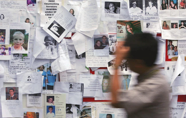 A man looks over hundreds of missing notices that have been put up at the Tsunami Co-Ordination and Relief centre at Phuket Town Hall.