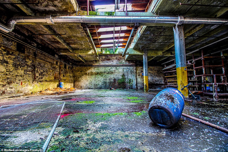 Sunlight shines through onto the crumbling floors of the once thriving factory which is nestled within the moorlands of The Pennines