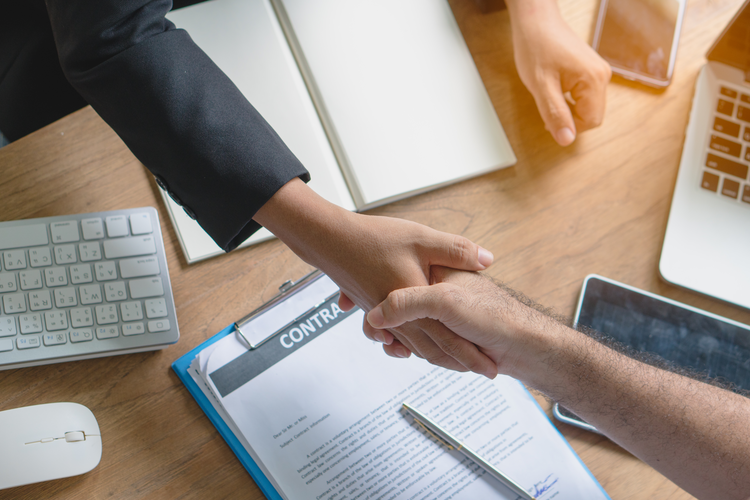 Business partners shake hands.
