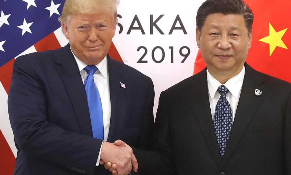 Chinese President Xi Jinping shakes hands with President Donald Trump in June in Japan. They are the primary actors in the longest-running, most serious trade war in history.