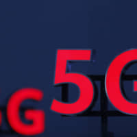 Iluminated 5G logos are on display during the 10th Global mobile broadband forum hosted by Chinese tech giant Huawei in Zurich Oct. 19. T-Mobile said on Monday it became the first to launch 5G wireless service across the United States, although it will be slower than some expected for the new generation of connectivity.