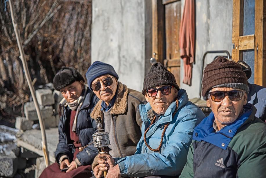 A group of Buddhist men outside a shop in Wakha, Kargil