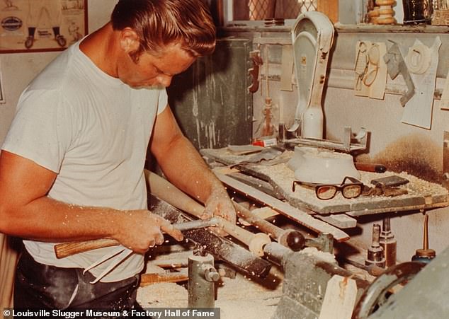 An unidentified man whittles down a baseball bat. In celebration of Louisville, Kentucky's biennial, the Louisville Slugger Museum is hosting an exhibit that showcases vintage photos of employees that worked in the Hillerich and Bradsby factory over the years. A local campaign asked family, friends and former colleagues to help identify the nameless faces