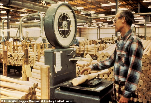 Employee Ray Sizemore weighing a roughout in 1975