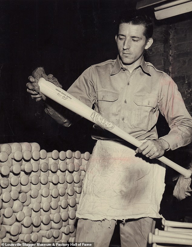 Employee rubbing bat with steel wool prior to final finishing operations in 1953