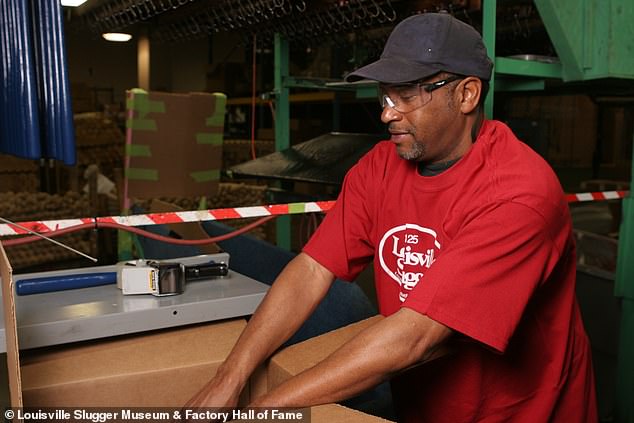 Employee (William White) packing mini-bats. March 2007