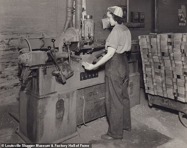 An unidentified female employee is seen placing a gunstock cutout on a table saw. Hillerich and Bradsby produced wooden rifle stocks and billy clubs for the U.S. Army during WWII