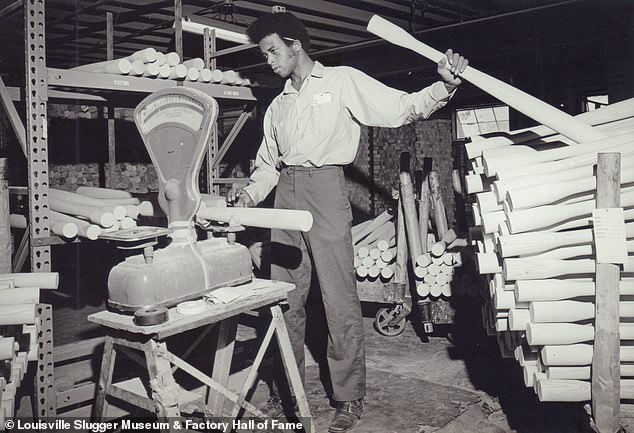 Employee weighing roughouts to determine for which model they’re best suited. Date unknown