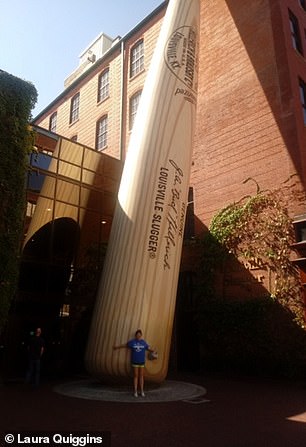 Laura Quiggins stands in front of the worlds largest baseball bat outside the Louisville Sluggar Museum in Kentucky