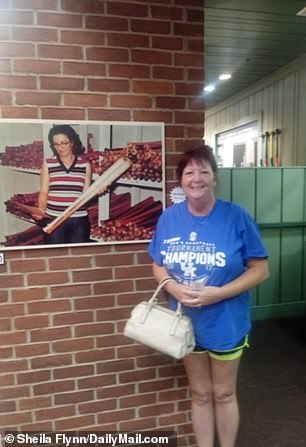Laura Quiggins poses next to a photo of her aunt Ruby Judd who was a long-term employee of Hillerich and Bradsby. Quiggins said, '...it was a family-oriented place … Everybody knew everybody. She loved working there'