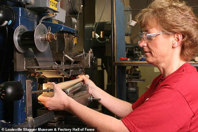 Employee Tammy Jobe branding mini-bats. March 2007