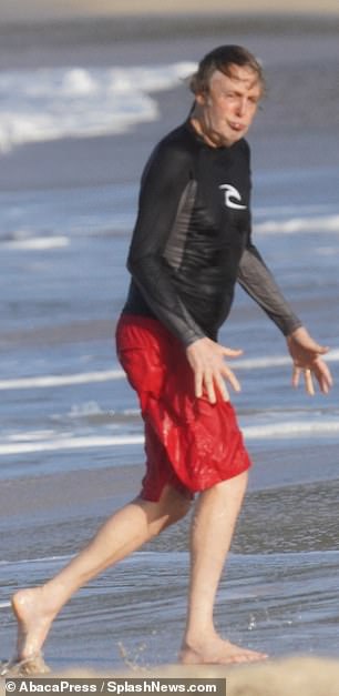 Blissful: The legendary rocker was seen sprinting into the French Caribbean island's clear azure waters