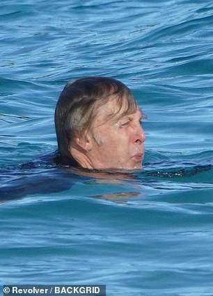 Taking a dip: Paul was in his element as he enjoyed a low-key swim