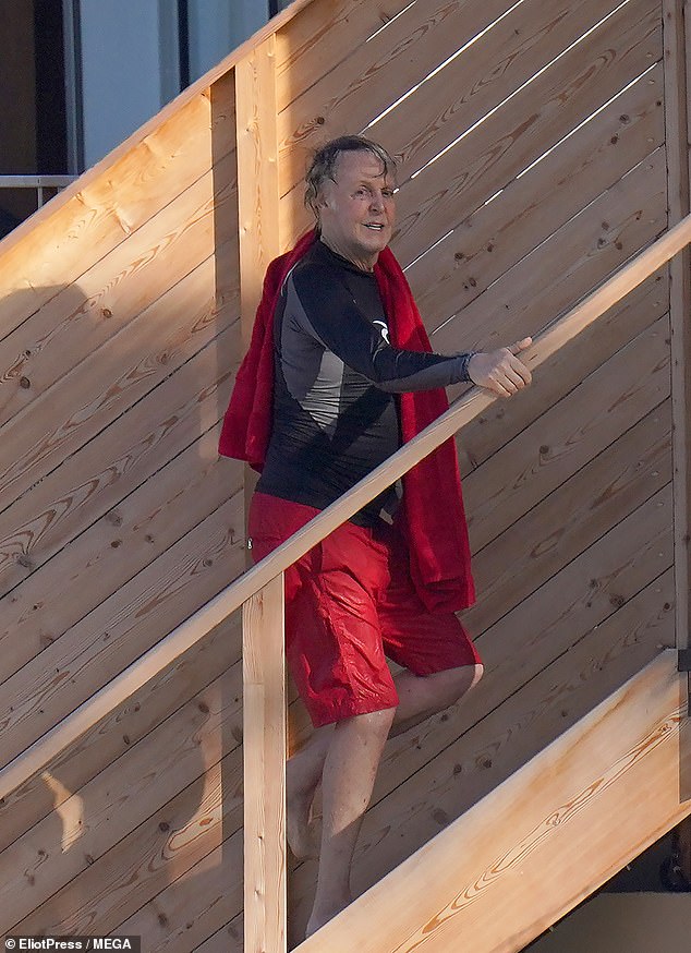 Cheery: The media personality flashed a wide grin as he returned to his accomodation