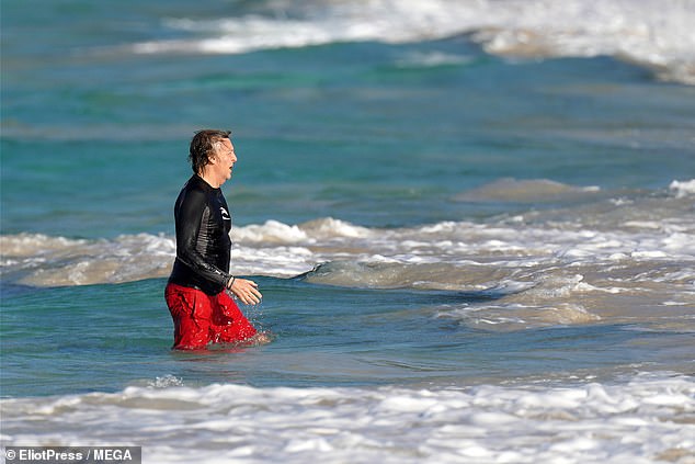 Fitness: The Hey Jude hitmaker, 77, donned a bright pair of red swimming trunks and a long-sleeved black top for his afternoon swim