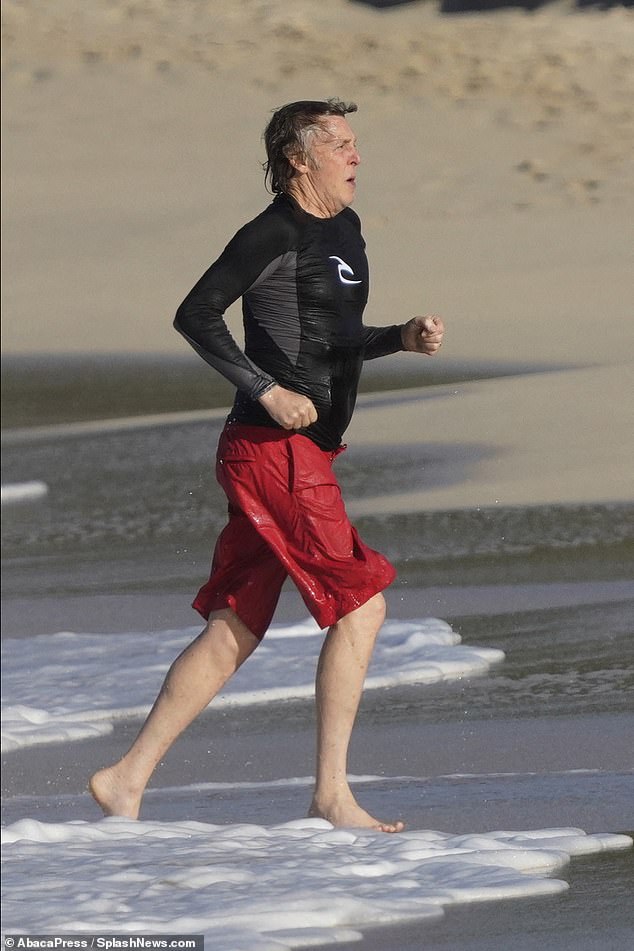 Well-paced: Paul kept up his run until he reached his towel, heading out of the crystal clear water at speed