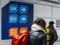 London Gatwick, March 2nd, 2018: Passengers walks past sign prior to immigration control pass a sign pointing towards queues for UK, EU and Non-EU passport holders. In April 2019, UK is set to leave the European Union - Brexit theme