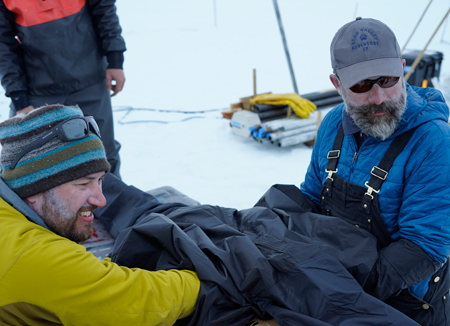 Two researchers work inside a lightproof bag. Two researchers work inside a lightproof bag.