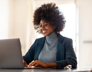 young businesswoman sitting in office smiling