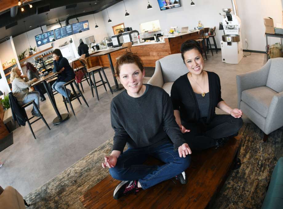 In this Jan. 10, 2020 photo, Balancing Goat Coffee Co. co-owners Karen Schmidt, left, and Dawn Hager poose in their specialty coffee, pastries, fresh fruit, smoothies, sandwiches and wellness studio at a strip mall in Mandan, N.D. (Mike McCleary/The Bismarck Tribune via AP) Photo: MIKE MCCLEARY, AP / The Bismarck Tribune