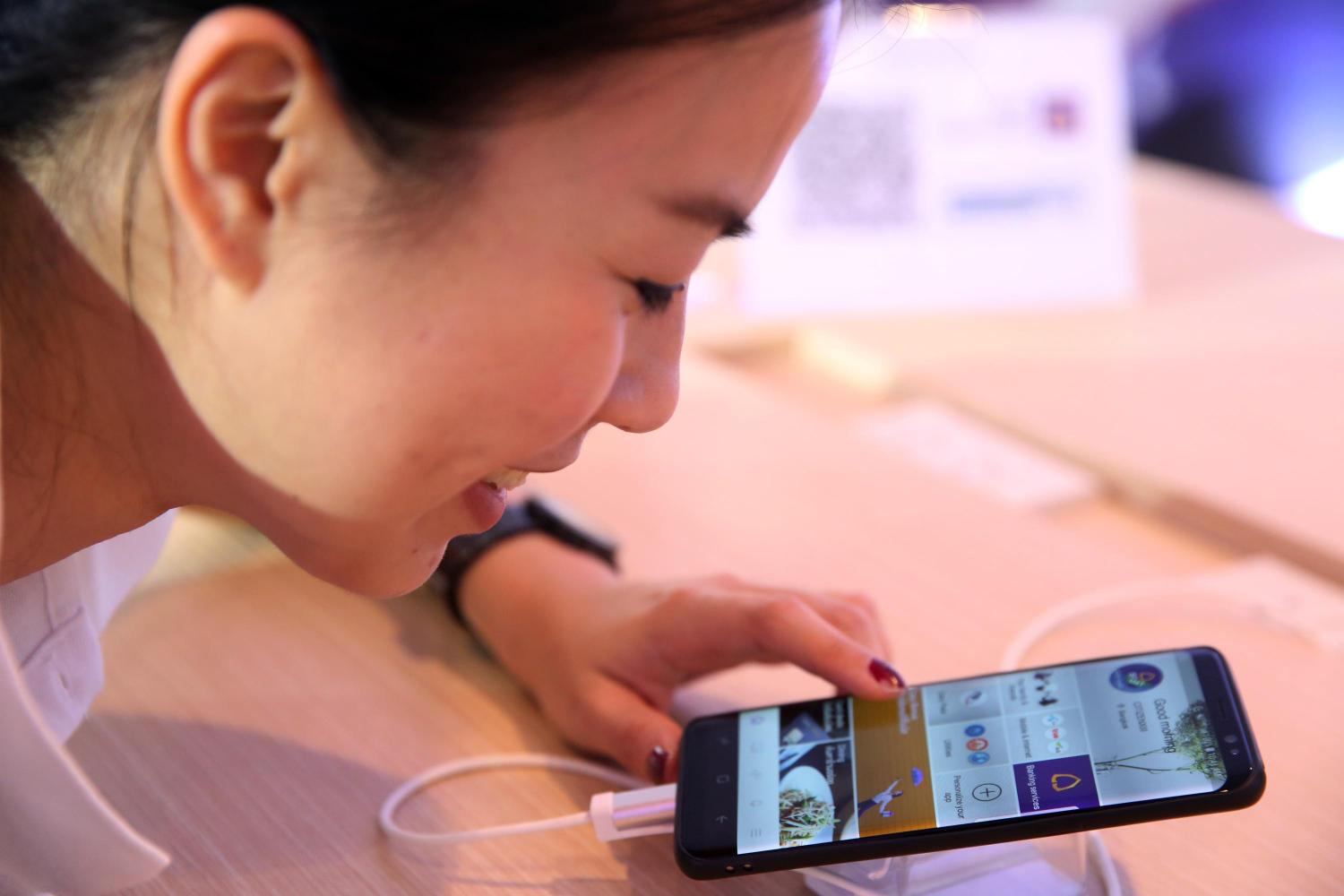 A customer browses SCB Easy, a mobile banking app.
