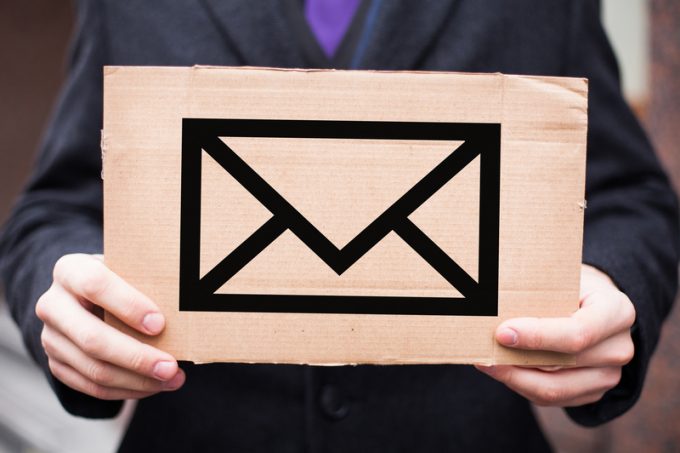 The concept of postal services and letters, mail. A man in a sui