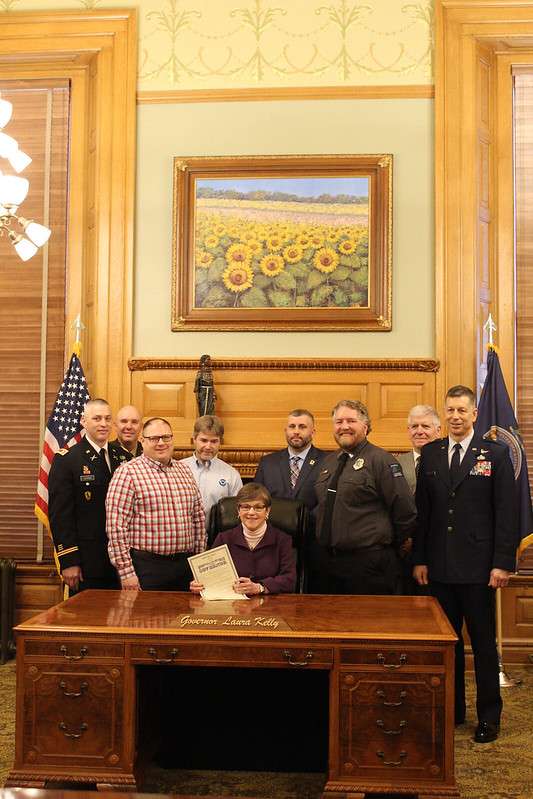 <b>Kansas Governor Laura Kelly (sitting) signed a proclamation Friday recognizing Feb. 3-7 as Wildfire Awareness Week in the state. </b>Photo Kansas Forest Service