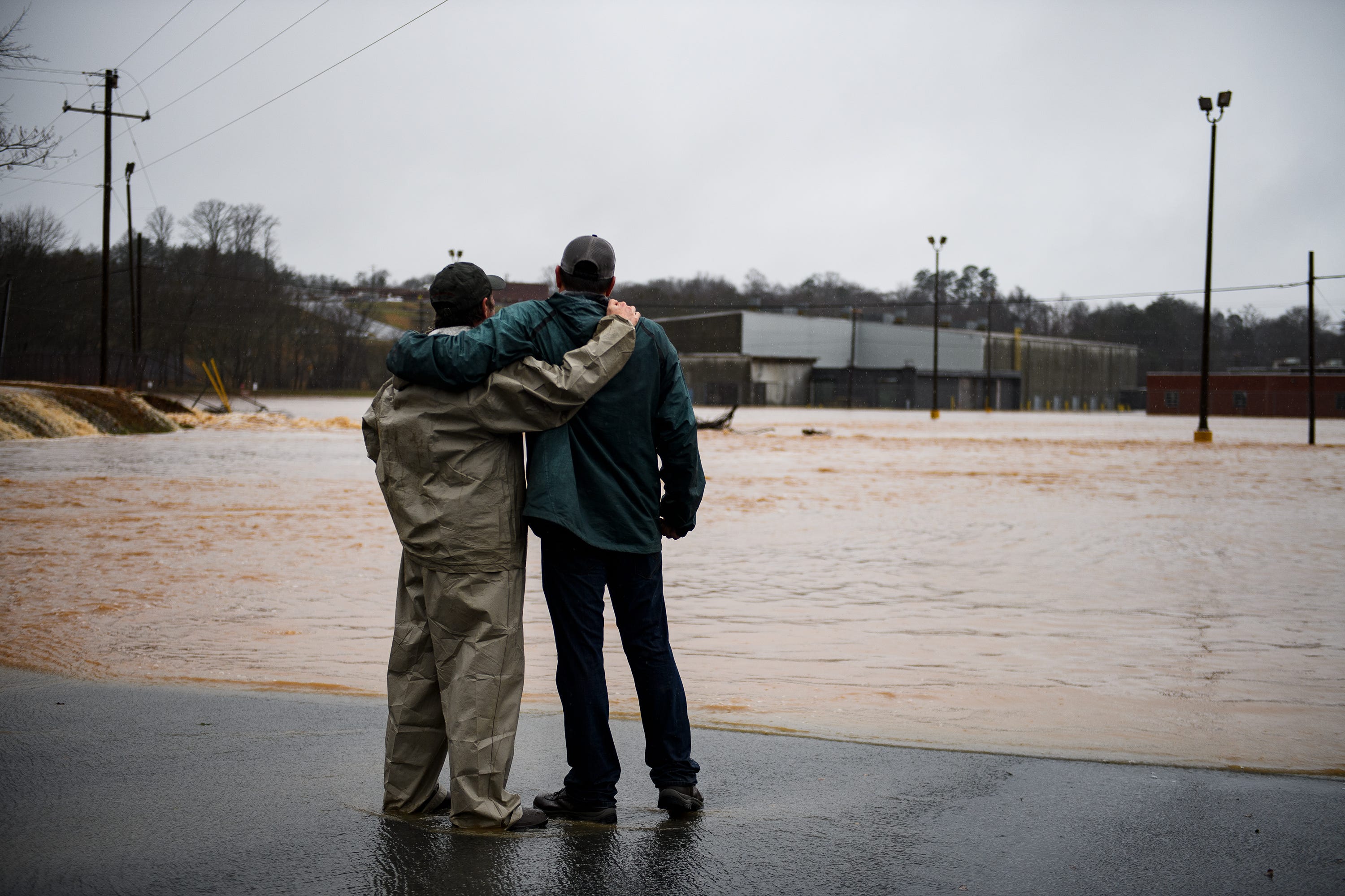 Barry Crawford puts his arms around Pat Mulkey after they were rescued from the former OWT Plant building in Pickens during a severe rain Thursday, Feb. 6, 2020. "It's heartbreaking," said Mulkey, whose business was going to open in two weeks in the converted building. "I recently moved the business back to my hometown from Greenville and lost it all. We lost everything." 