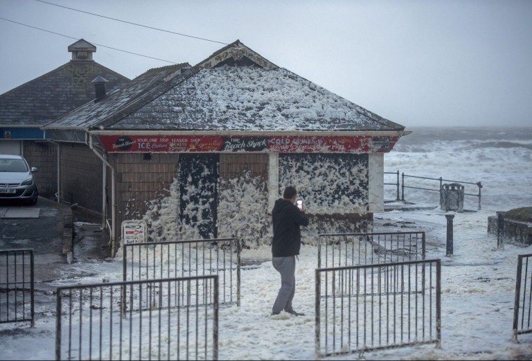 Mandatory Credit: Photo by Phil Rees/REX (10552056b) High winds from Storm Ciara whip up foam onto the road at Caswell Bay near Swansea Seasonal weather, Swansea, Wales, UK - 09 Feb 2020