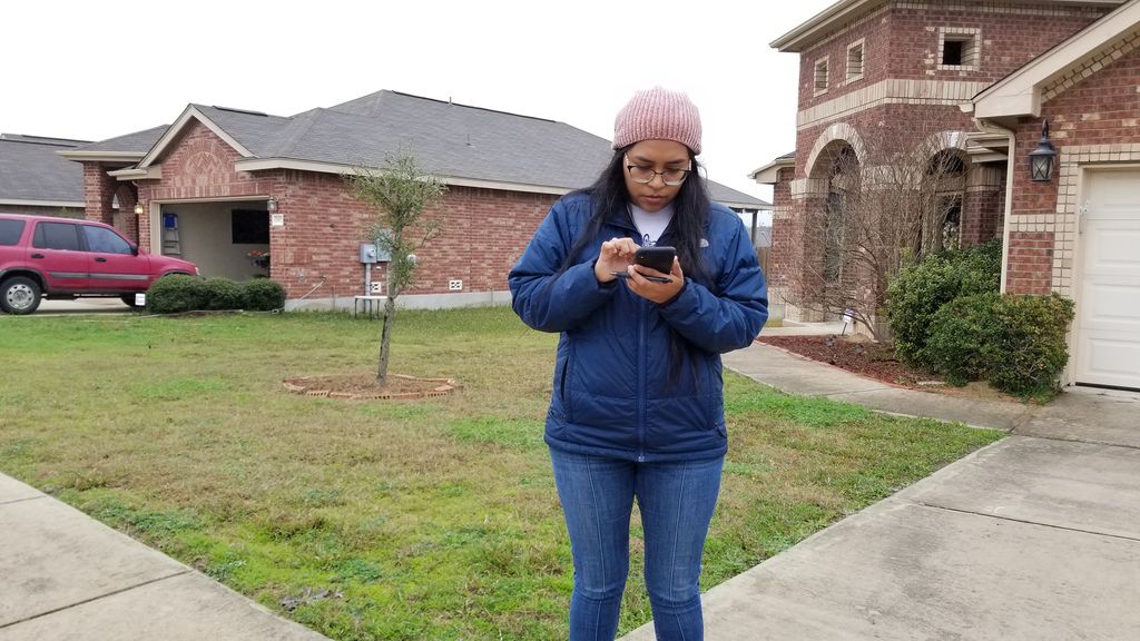 Congressional candidate Jessica Cisneros checks for the next home on her list as she campaigns in Live Oak, Texas, on Feb. 19, 2020.