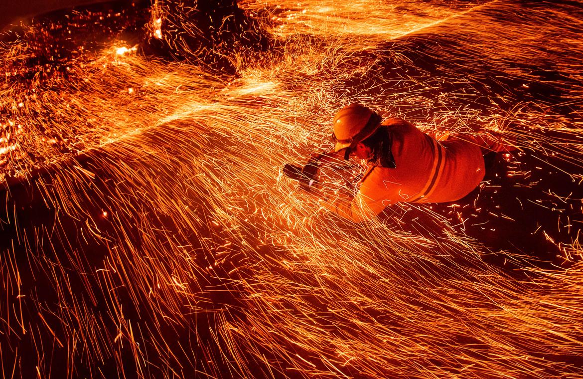 Noah Berger Noah Berger, "Justin Sullivan shooting low, Camp Fire," 2018. (Courtesy of the artist and Associated Press)