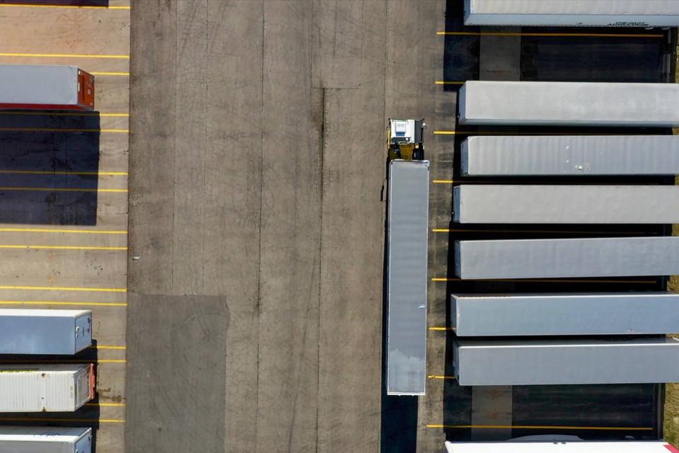 Outrider vehicle autonomously moving a trailer in a customer logistics yard.
