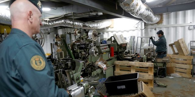 Spanish civil guards stand in an illegal underground tobacco factory during a police raid in Monda, near Malaga, in southern Spain.