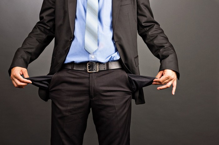 Businessman with no money in pockets