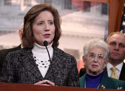 Rep. Vicky Hartzler, R-Mo., left, speaks to reporters on Capitol Hill in Washington, Tuesday, March 25, 2014, after the Supreme…