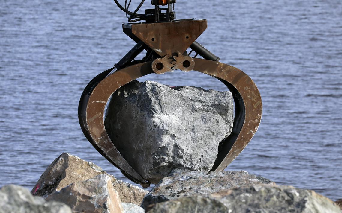 The grapple attachment on a material handler holds a rock weighing between six and 12 tons. (Steve Kuchera / skuchera@duluthnews.com)