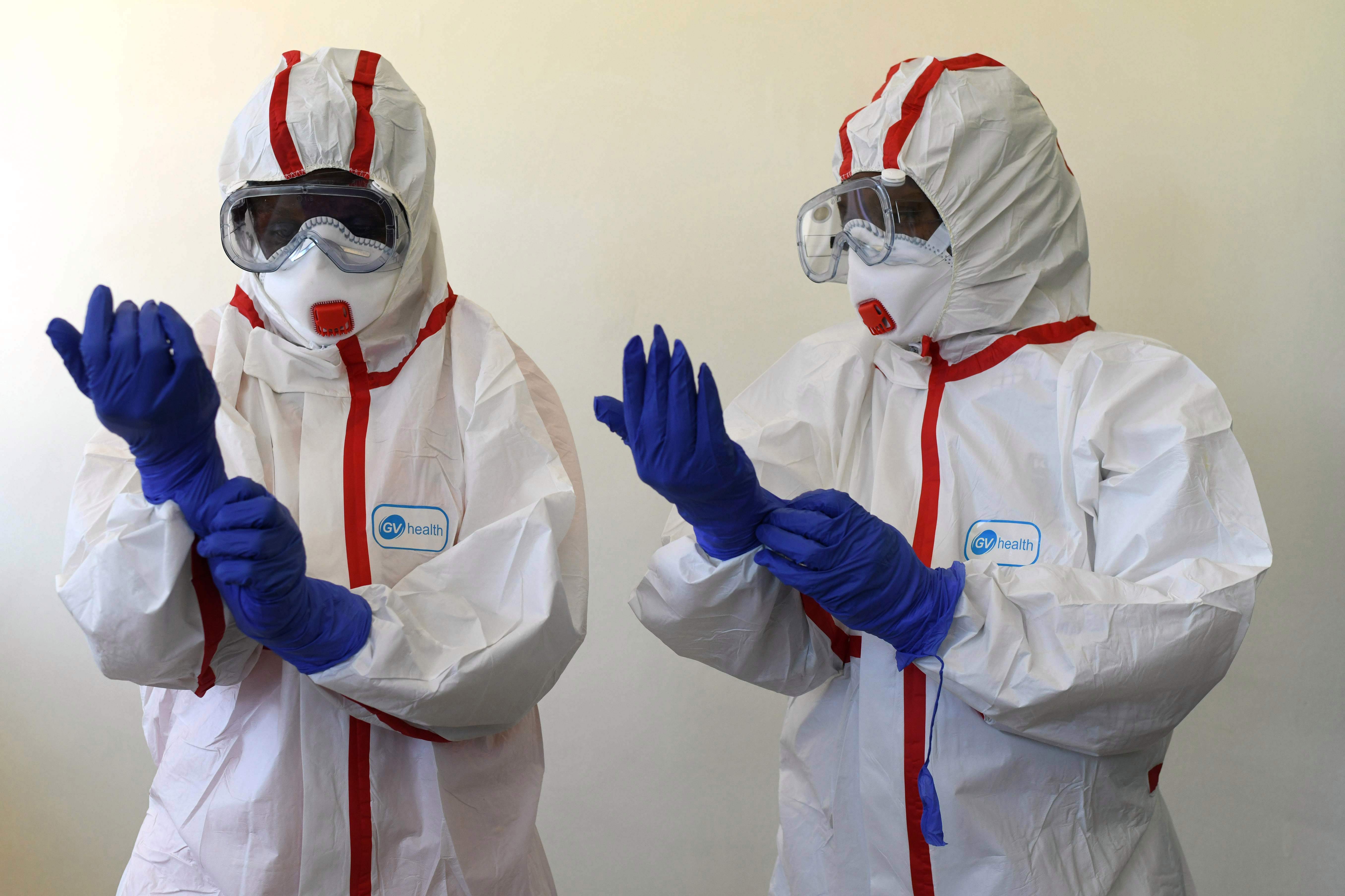 Kenyan health workers wear protective suits during a demonstration for preparations for any potential cases of the new coronavirus
