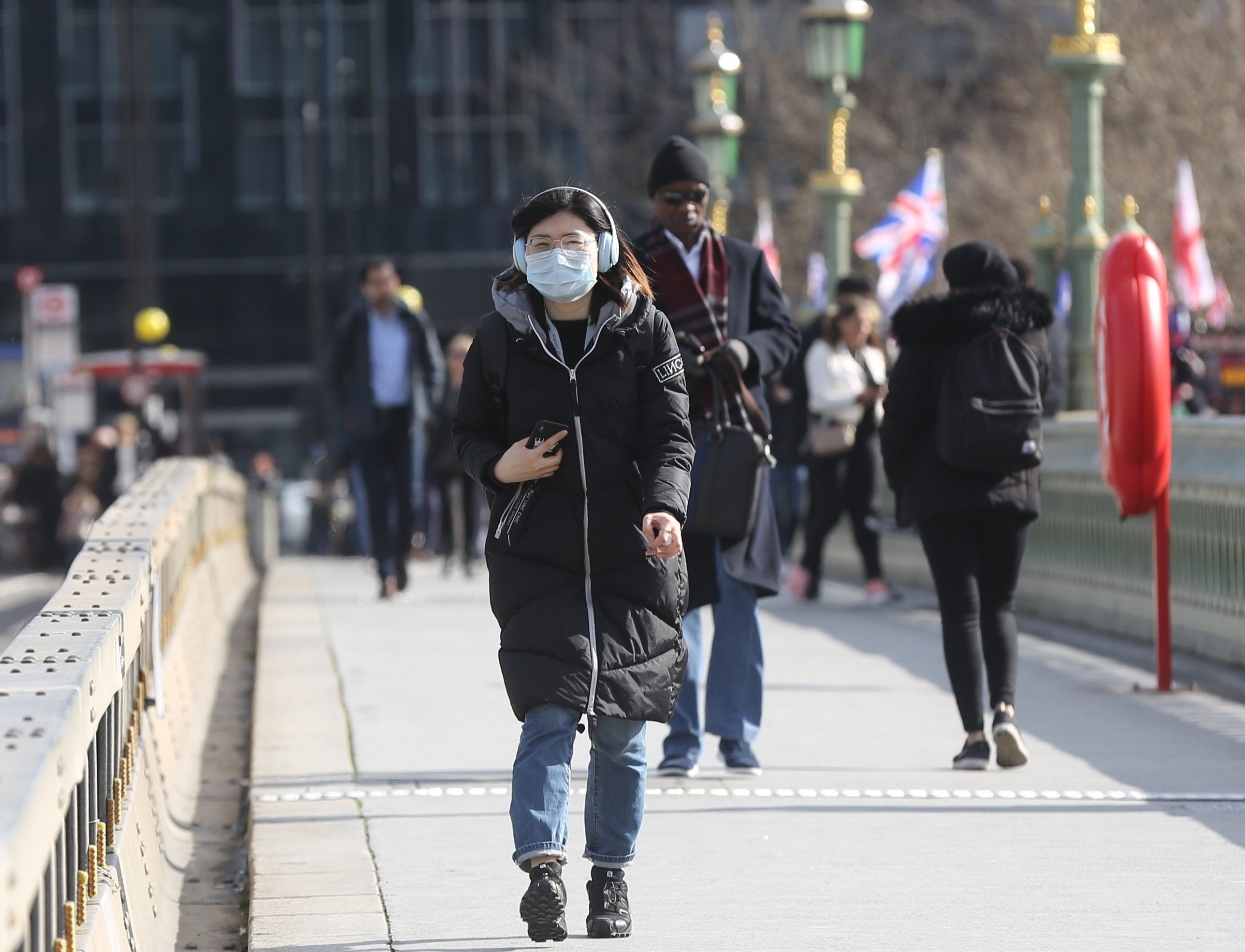 A woman wears a medical mask on Westminster Bridge as a precaution against coronavirus