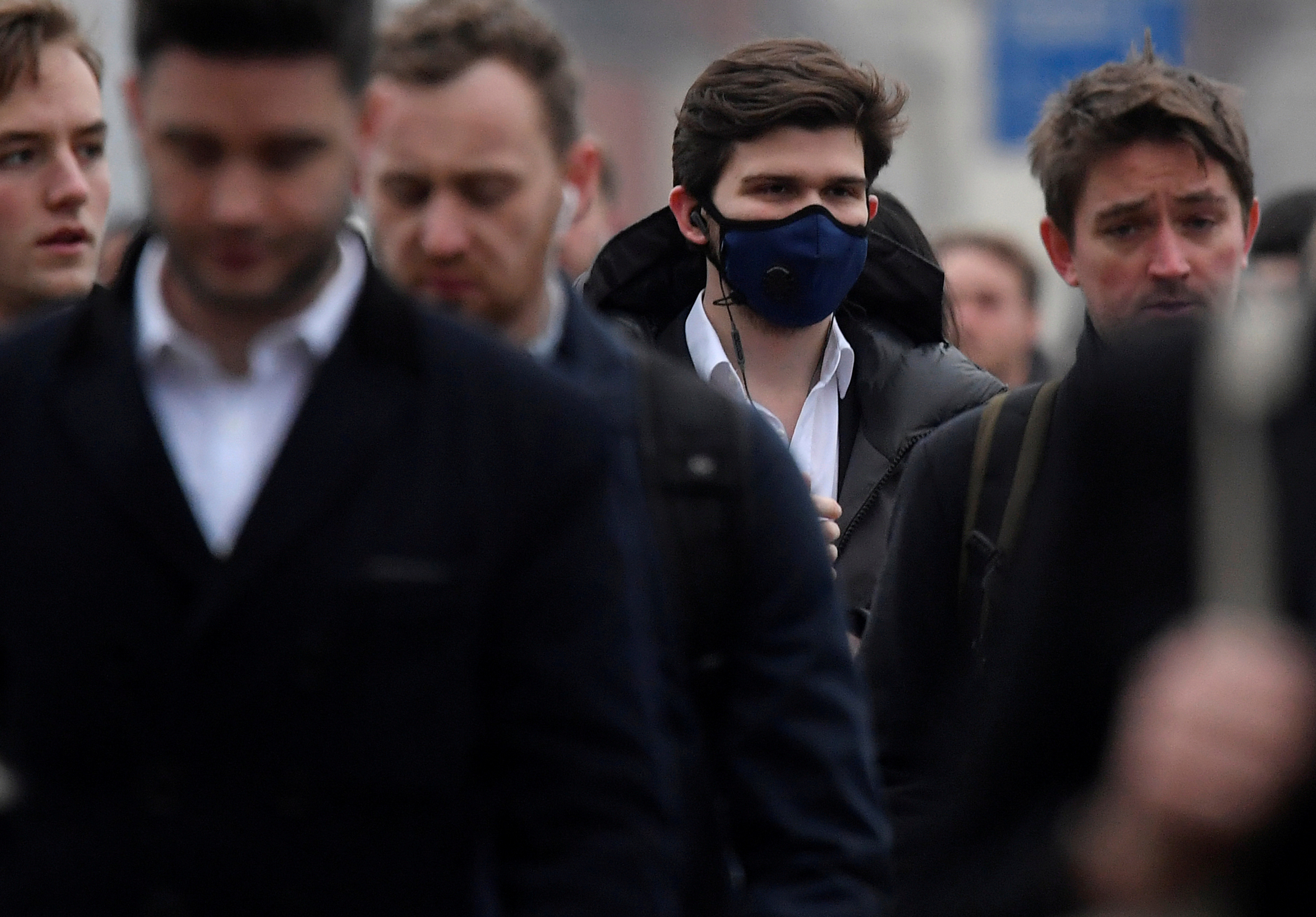 Members of the public wear face masks on London Bridge