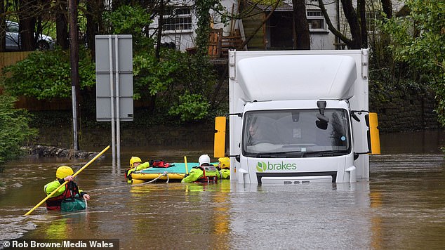 The bakery van was stranded after the River Ely broke its banks at St Fagans, in Cardiff, south-east Wales