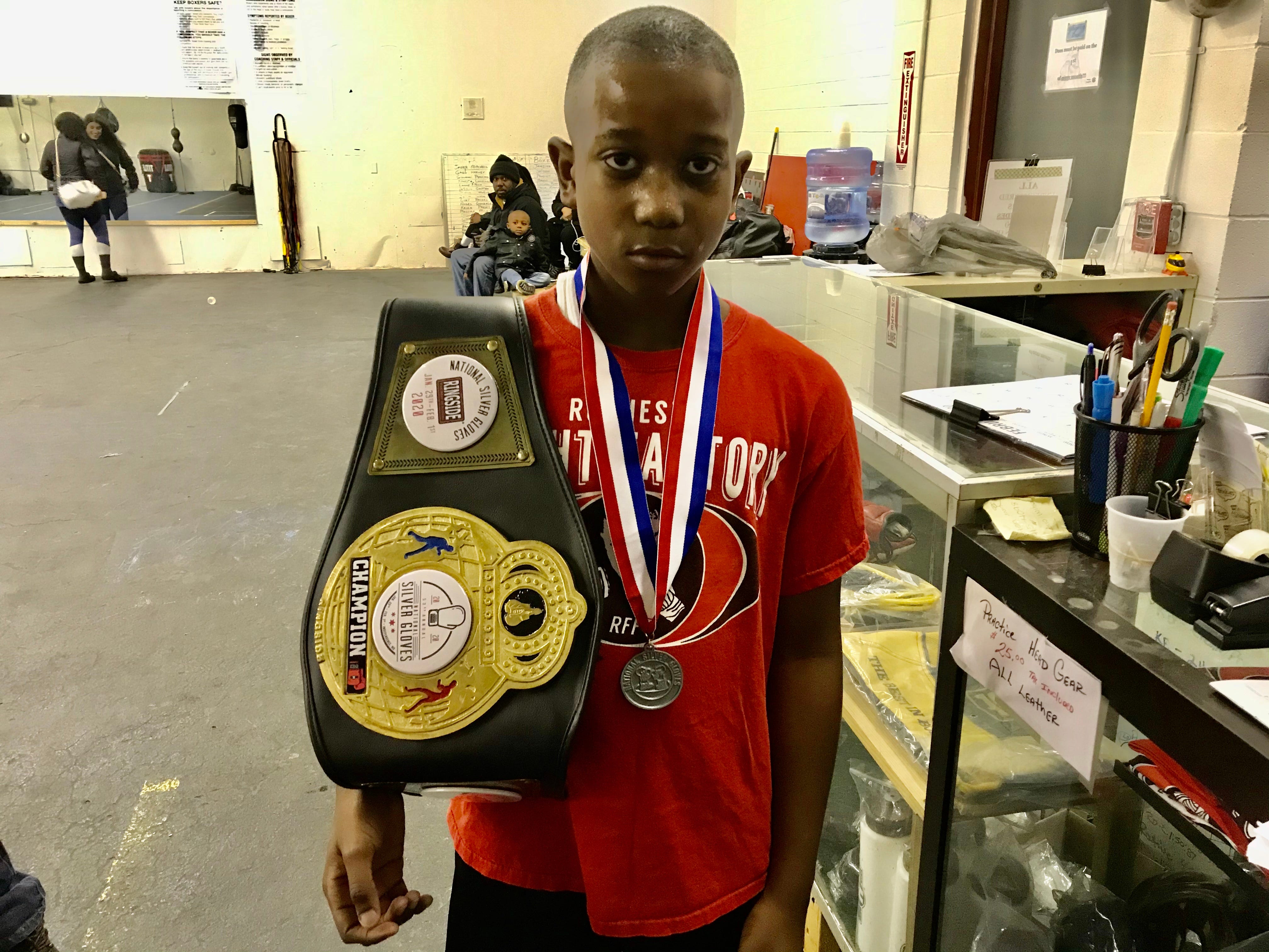 Zah'Mere Williams, 10, of Rochester 58 School and his national Silver Gloves title belt. He trains at the Rochester Fight Factory. “