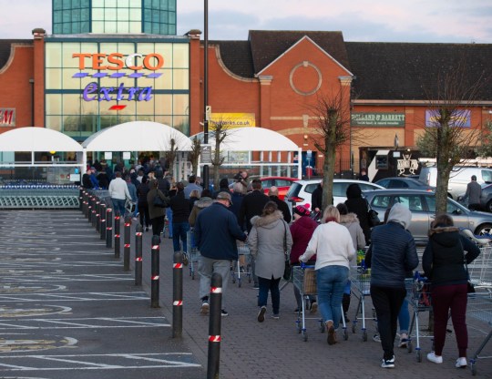 Mandatory Credit: Photo by Terry Harris/REX (10590058e) People queuing out of the door at 6am to shop at Tesco Extra,Hampton, Peterborough Coronavirus outbreak, UK - 21 Mar 2020