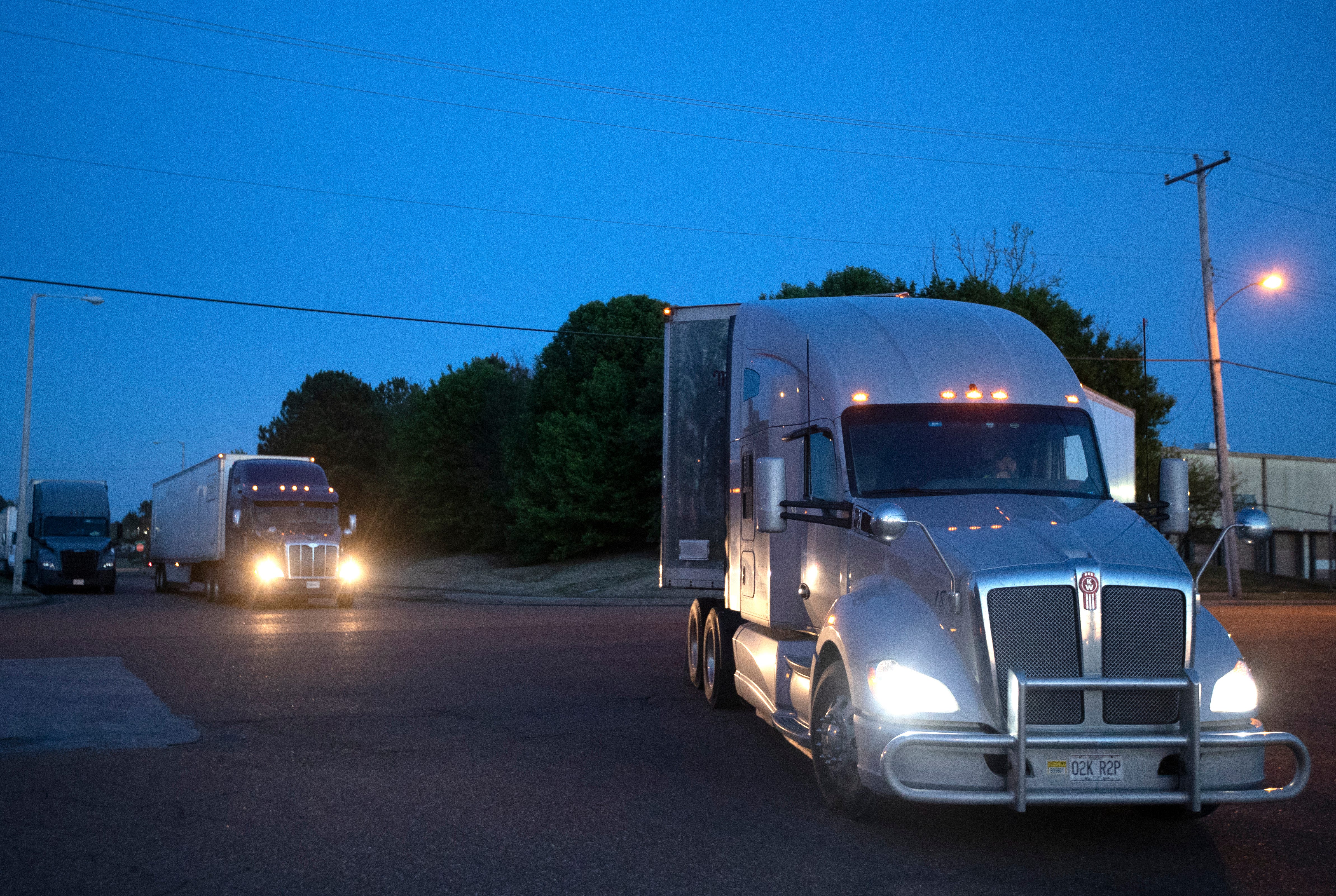 Semi-trucks line up outside of the Kroger warehouse after it became known that a worker tested positive for COVID-19, causing a work stoppage by concerned employees. 