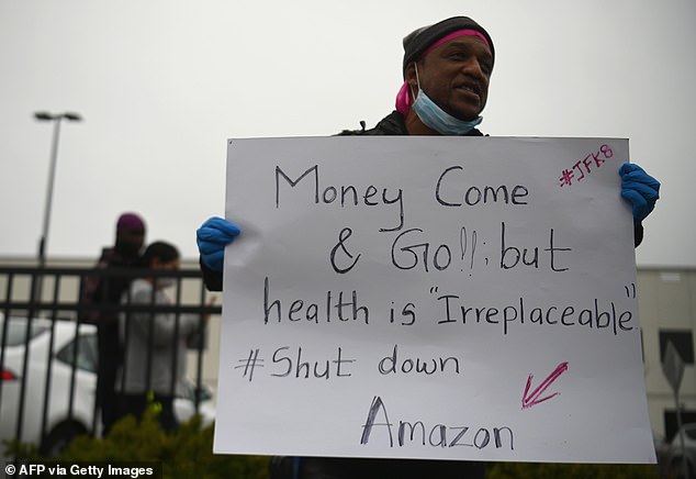 An Amazon employee protests against the company outside its facility in New York