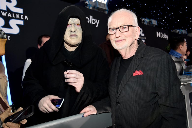 Ian McDiarmid greets a fan dressed as the Emperor on the red carpet at the premiere of Star Wars: The Rise of Skywalker.