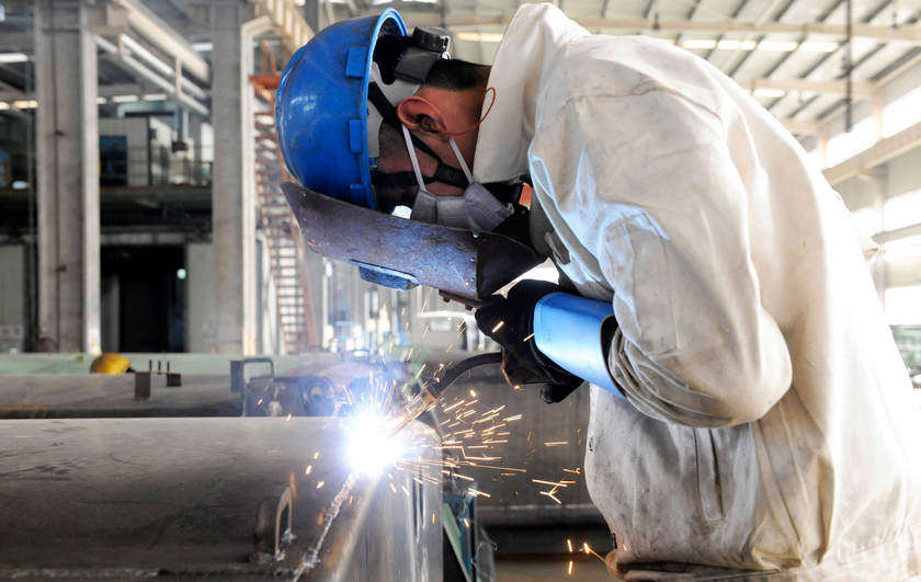 An employee welds the exterior of a vehicle in a Qingdao factory December 1, 2014. China said today the impact of the coronavirus pandemic on global supply chains will pressure Chinese exporters and importers. — Reuters pic