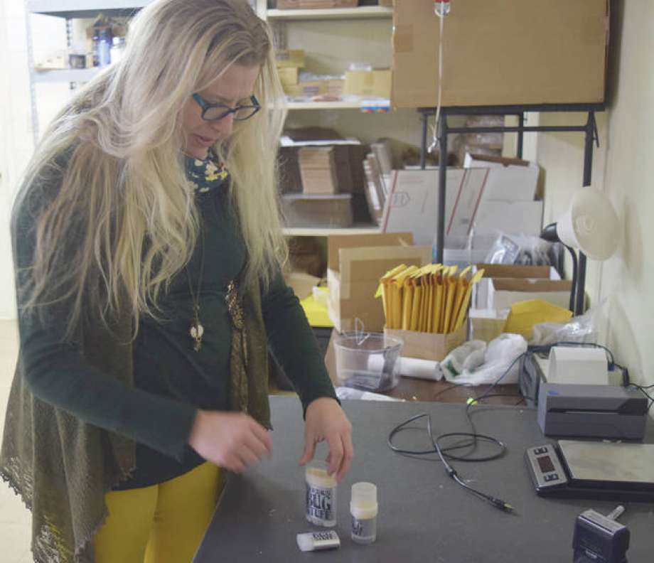 Megan Luckey, co-owner of Serious Lip Balm, shows off the company’s bug repellent balm “The Bug Stuff.” The balm has been entered in the The Illinois Manufacturers’ Association’s first Makers Madness contest. Photo: Marco Cartolano | Journal-Courier